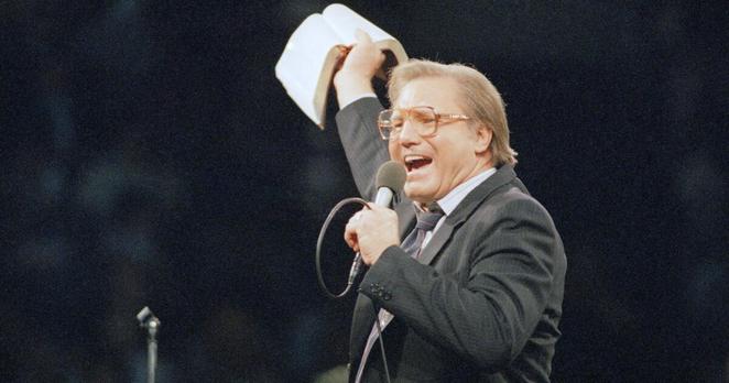 The Rev. Jimmy Swaggart gestures with the bible as spread the word of the Lord to the 14,000 faithful that packed the Los Angeles Sports Arena during his Los Angeles Crusade, Sunday, March 30, 1987. (AP Photo/Mark Avery)