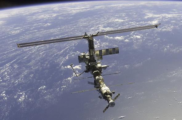 The International Space Station floats above the planet Earth.