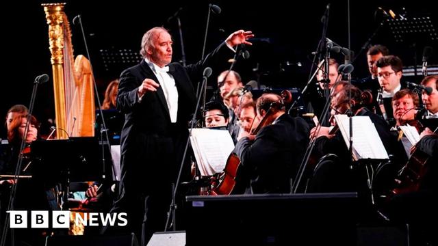 Russian conductor and Mariinsky Theater Artistic Director Valery Gergiev is surrounded by classical musicians on stage in Moscow in 2018.