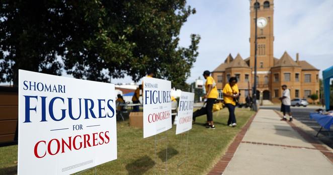 Campaign signs for Alabama's new 2nd Congressional District Democrat Shomari Figures decorate the lawn during the Macon County Day Festival in Tuskegee, Ala., on Saturday, Aug 31, 2024. (AP Photo/ Butch Dill)