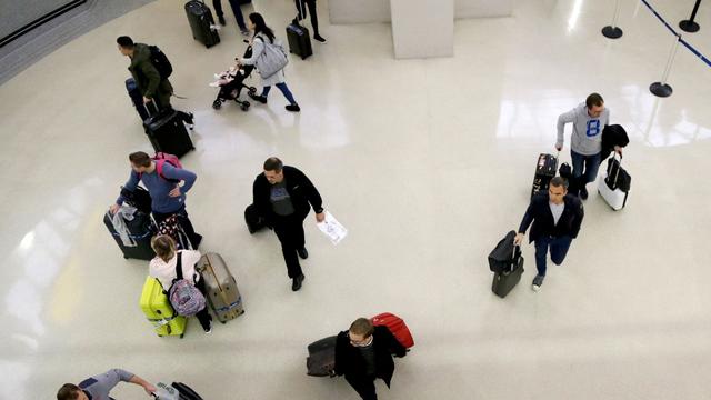 Passengers arriving at arrivals terminal. | Copyright AP Photo