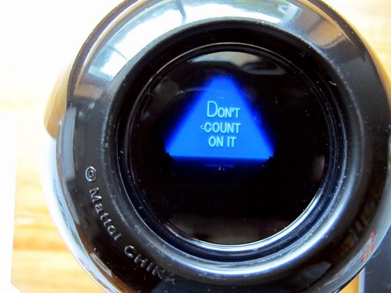 Magic 8 ball toy, a black sphere with a window that shows one of a fixed set of answers to any question. In this case, the ball is showing the answer "Don't count on it".