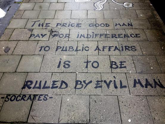 Image of graffiti on pavement outside EU Commission headquarters: “The price good men pay for indifference to public affairs is to be ruled by evil men” Image of graffiti on pavement outside EU Commission headquarters: “The price good men pay for indifference to public affairs is to be ruled by evil men”