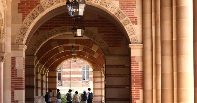 WESTWOOD, CA - JULY 15, 2025 - - Visiting students walk down a corridor outside Royce Hall on the UCLA campus at the height of summer in Westwood on July 15, 2025. (Genaro Molina/Los Angeles Times)