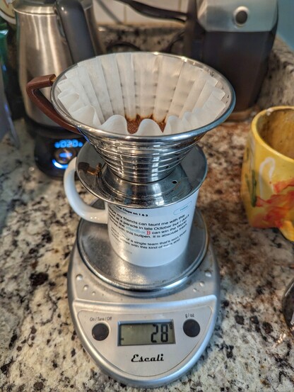 A pour over coffee using a Kalita Wave on a scale.